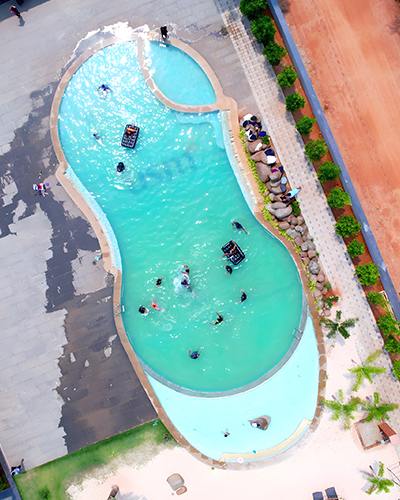 People relaxing at Go Ranch Resort's beach swimming pool.