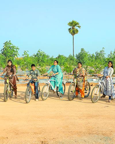 Cyclists enjoying a ride at Go Ranch Resort, surrounded by scenic landscapes and lush greenery