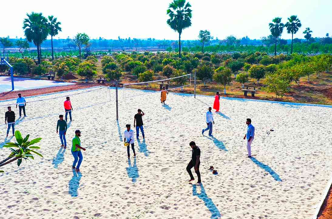 Group enjoying sand volleyball at Go Ranch resort near Hyderabad